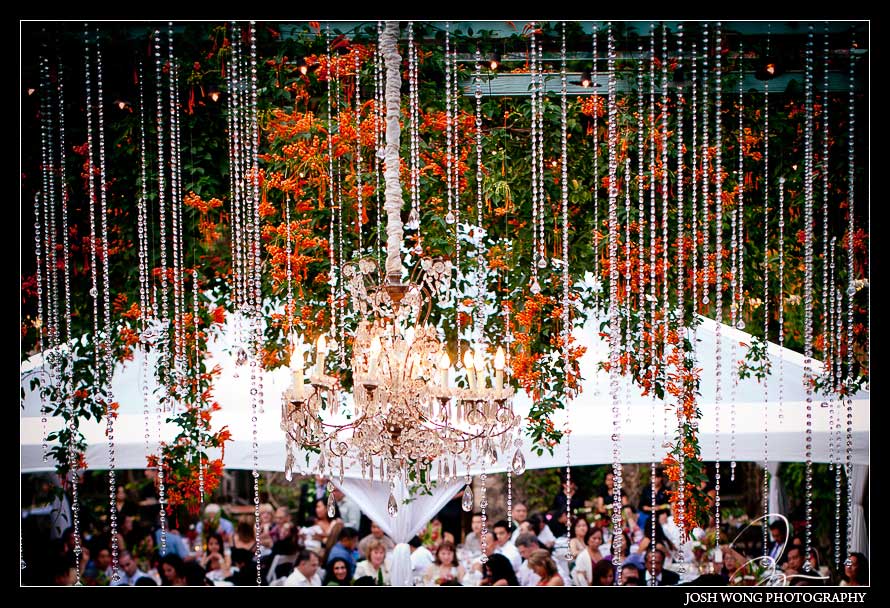 Elaborate crystal chandeliers hang from open air ceiling of Haiku Mill. Haiku Mill Destination Wedding, Maui Hawaii - Wedding Pictures by Destination Wedding Photographer Josh Wong Photography