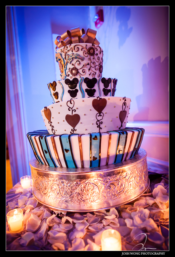 A whimsically inspired topsy turvy 4 tiered wedding cake.  