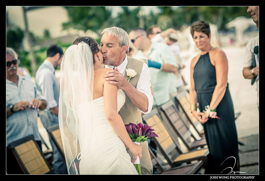 Father of the bride kisses his daughter as he give her away.Destination Wedding at Grand Velas Resort in Playa Del Carmen, Mexico. Wedding Pictures and photos by top destination wedding photographer Josh Wong Photography