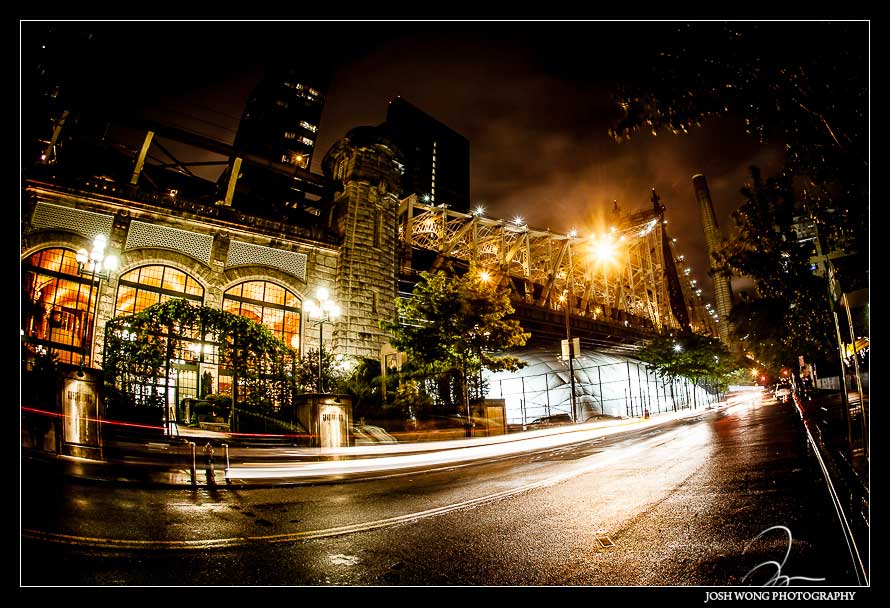A spectacular nighttime view outside the doors of Guastavino's with the Queensboro Bridge in the background. A Guastavino's Wedding by NYC Wedding photographer Josh Wong 