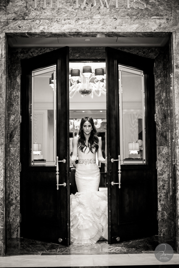 The bride emerges from the bridal suite after getting in her wedding dress.
