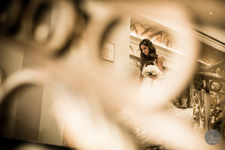 First Look: The bride walking down the stair to see the groom for the first time. A Lotte New York Palace Hotel Wedding by Josh Wong Photography