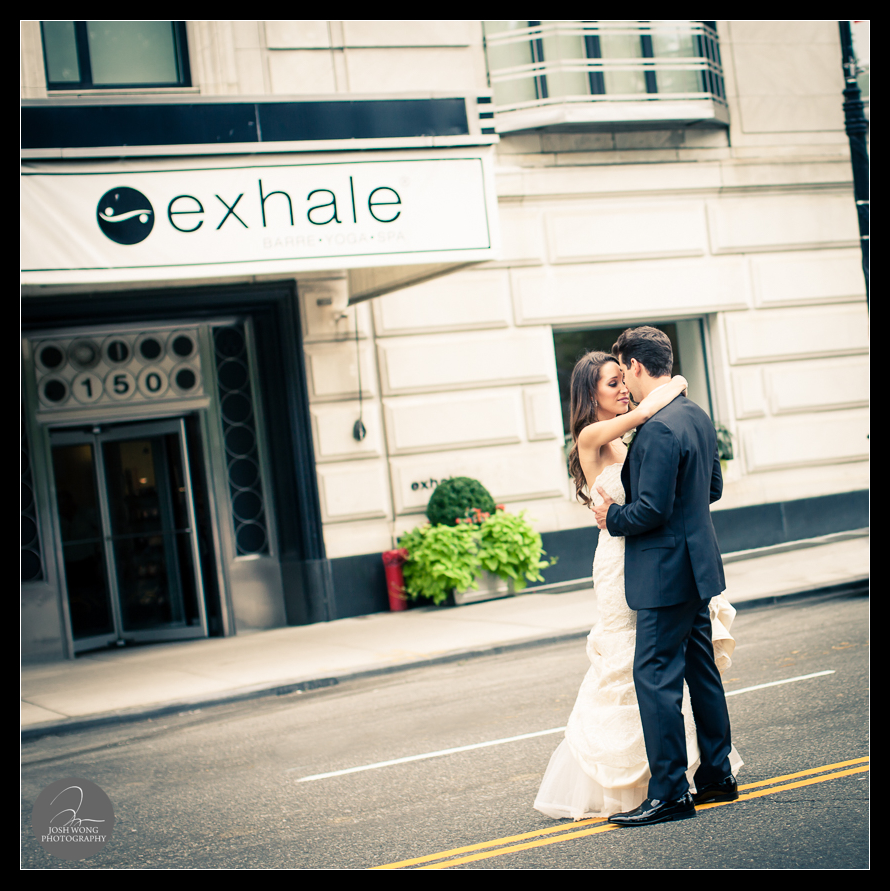 The bride and the groom share an intimate moment outside of the Essex House before heading to Central Park for bride and groom wedding portrait pictures.  JW Marriott Essex House Wedding. Wedding Pictures and photos provided by Josh Wong Photography, New York City