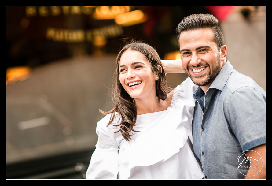 The happy couple enjoy a laugh together. Engagement photo taken by Josh Wong Photography
