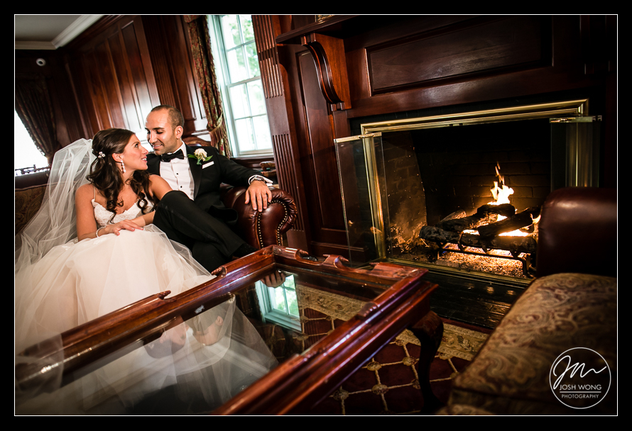 The bride and groom enjoy a moment together by the fireplace at the Royalton Mansion. Wedding pictures by Josh Wong Photography