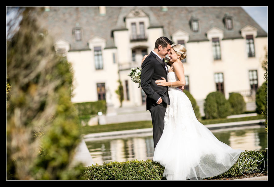 Oheka Castle Front Garden - The couple enjoy a moment together in the front garden with a view of the castle in the background. images by Josh Wong Photography