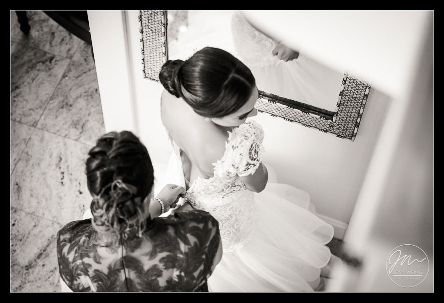 The bride slipping into her wedding dress.  New York Wedding pictures by Armenian wedding photographer Josh Wong Photography