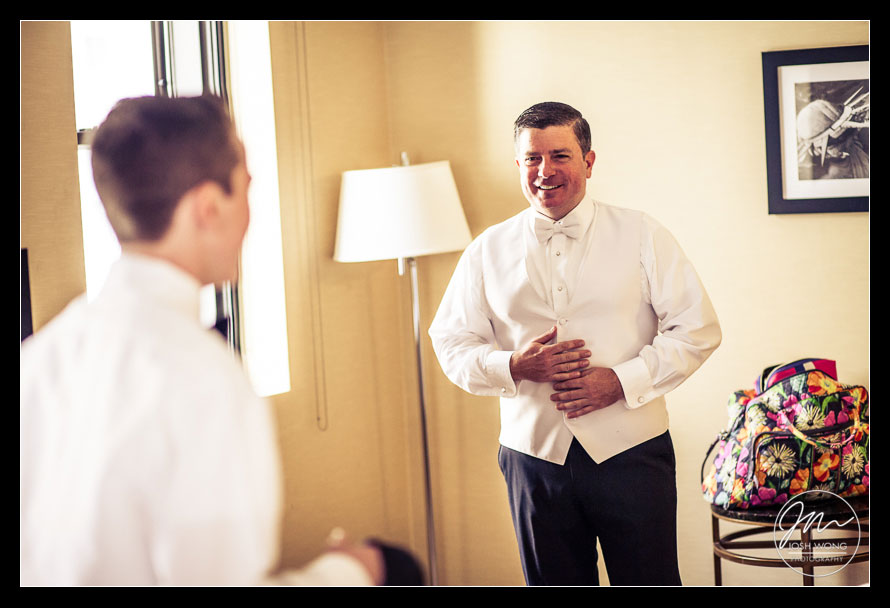 The groom son helps his father with the cuff links at the Waldorf Astoria.