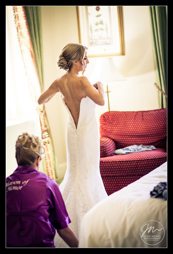 The matron of honor helping the bride into her beautiful Vera Wang wedding dress. photo by Top New York Wedding Photographer Josh Wong