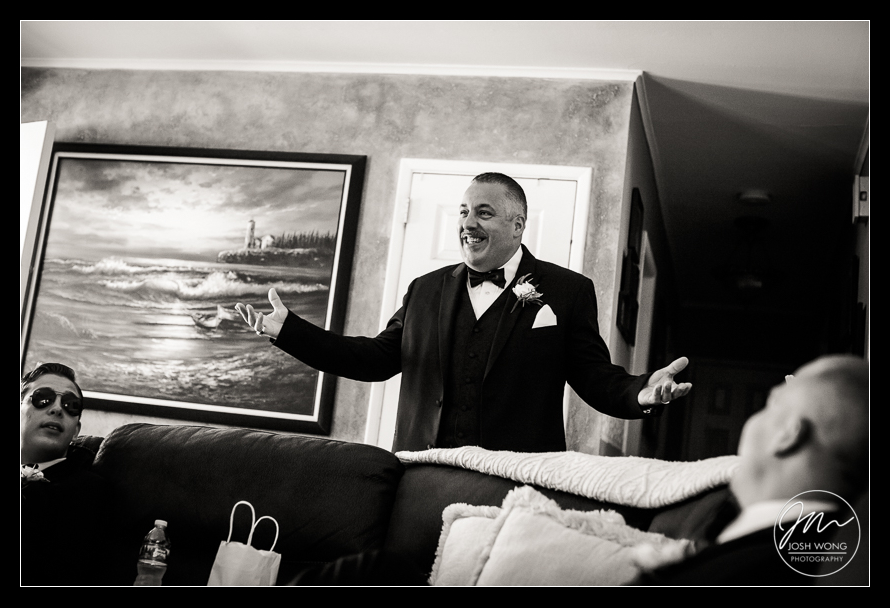 Father of the bride has a moment with the groomsmen. Best candid moments with the groom getting ready at his parent's home. Wedding photos by top New York wedding and fashion photographer Josh Wong Photography