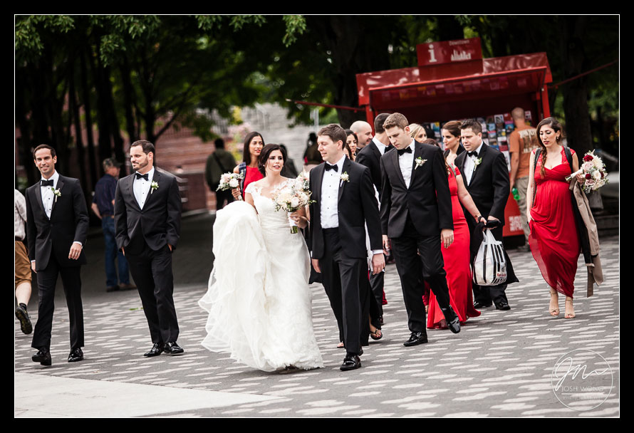 The bride and grooms bridal party walk the streets of Battery Park in Downtown Manhattan.