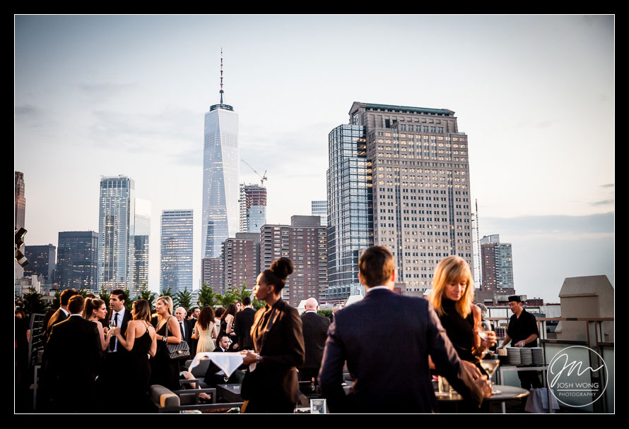 Guest enjoy the cocktail hour on rooftop with the Freedom Tower as their backdrop. Tribeca Rooftop Wedding