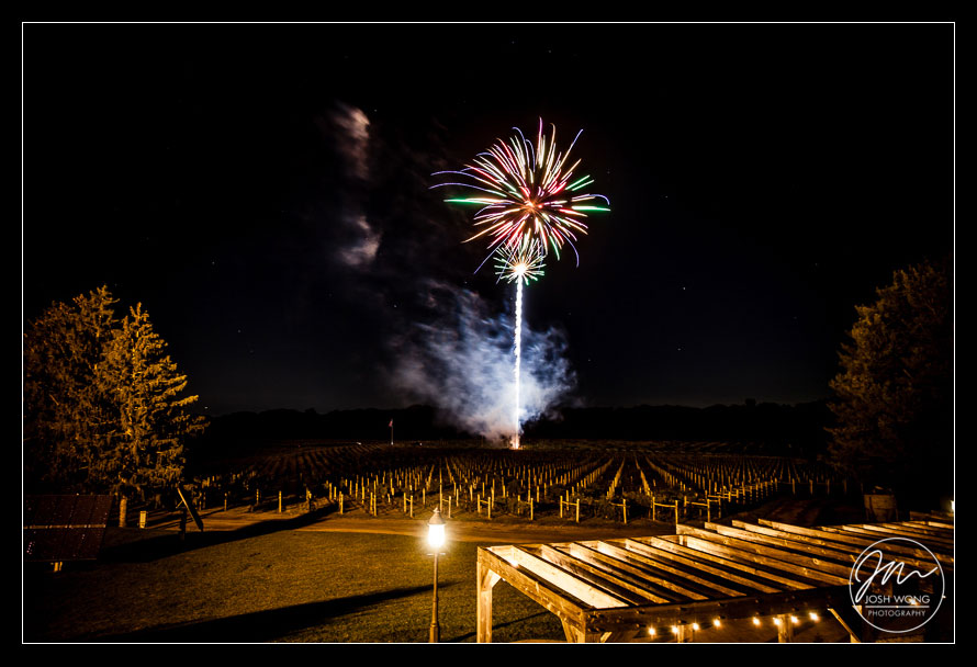 Fireworks are set off in the distance and over the vineyards.