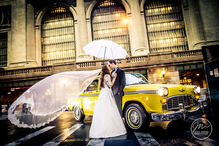 A rainy day Grand Central Terminal Wedding picture with a vintage taxi by Josh Wong Photography