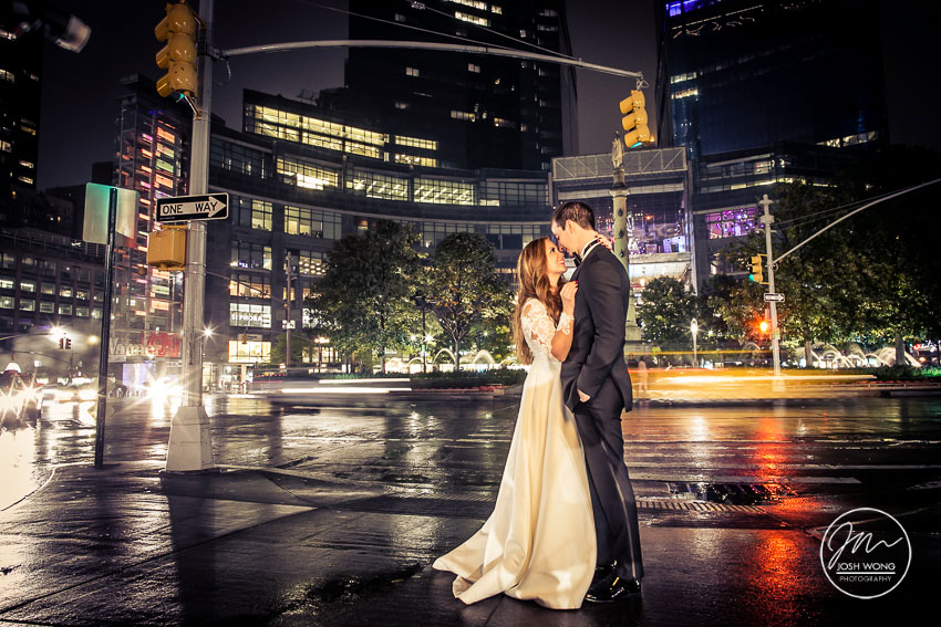 A evening wedding photo in Columbus Circle in New York City. Photo taken by Josh Wong Photography.