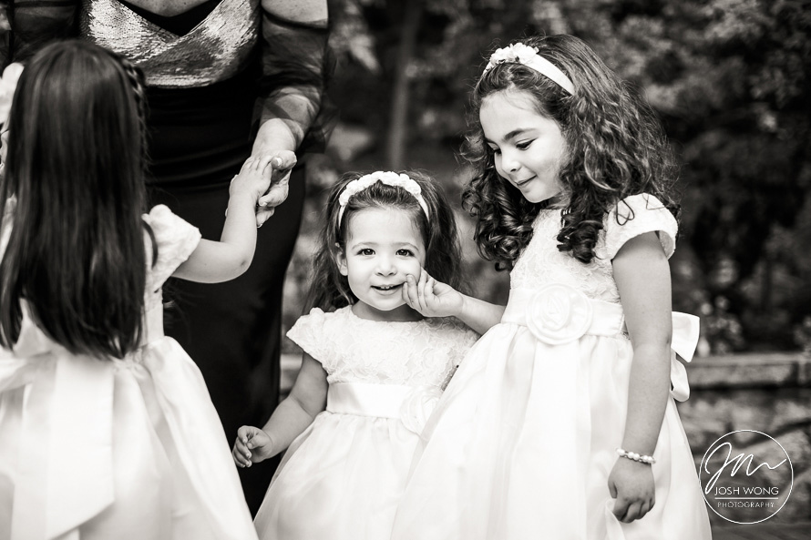 The flowers girls hand a candid moment. Gorgeous wedding photography at Tappan Hill Manion in Tarrytown. New York Wedding Pictures by Josh Wong Photography