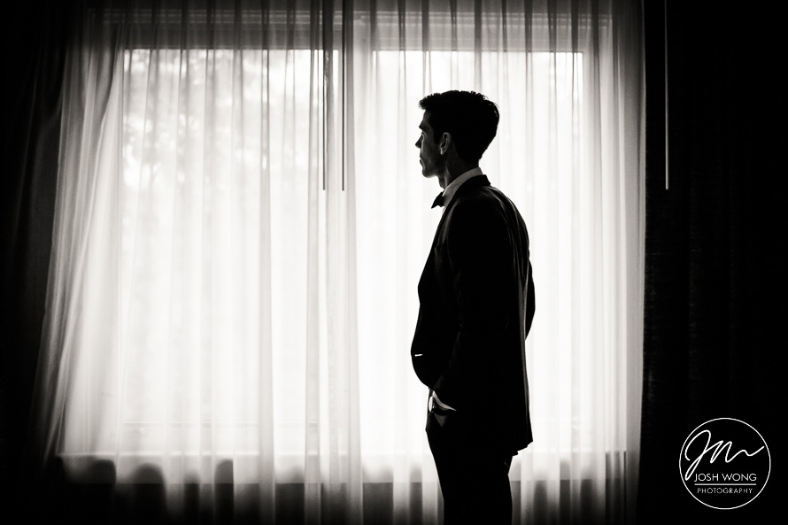 The groom finishes getting ready and await the first look.