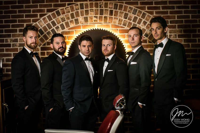The groomsmen hangout in the barbershop at Pleasantdale Chateau. Wedding photos by Josh Wong Photography