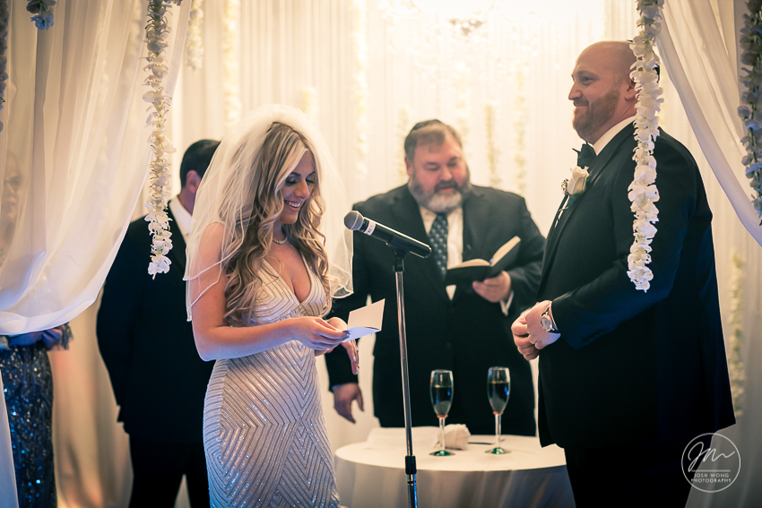 In the moment with the bride and groom exchanging vows. Best wedding candid moments at The Venetian in Garfield, NJ. Wedding photos by Josh Wong Photography