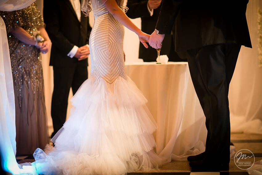In the moment with the bride and groom exchanging their rings. Best wedding candid moments at The Venetian in Garfield, NJ. Wedding photos by Josh Wong Photography