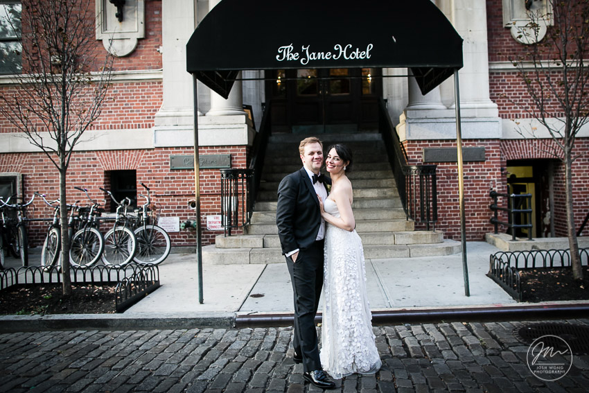 The wedding couple pose in front of the Jane Hotel. Wedding photos by Josh Wong Photography