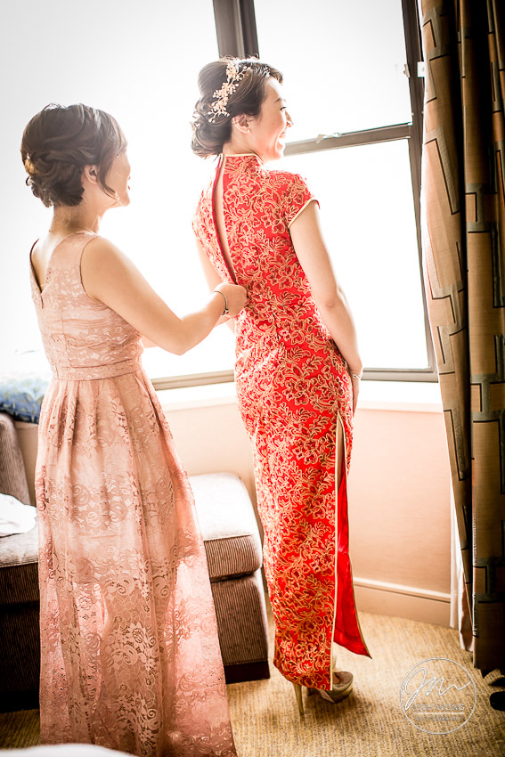 The bride changes into a traditional Chinese long dress ahead of the Tea Ceremony.