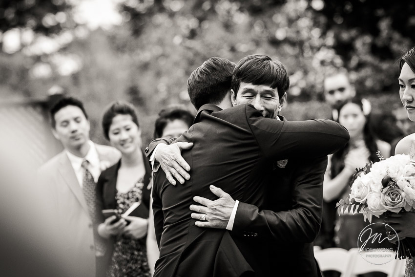 Father of the bride and groom hug.  New York Botanical Garden Wedding Pictures by NYC Wedding Photographer Josh Wong Photography