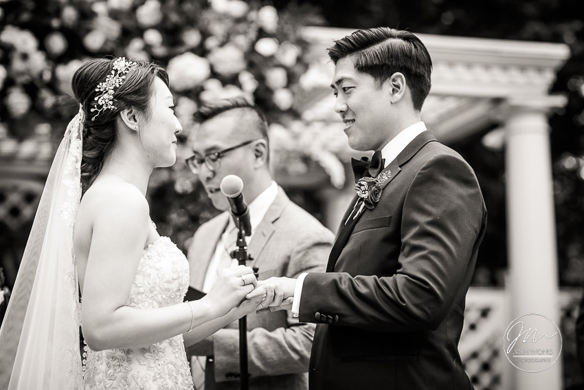 The couple exchange rings while saying their vows. New York Botanical Garden Wedding Pictures by NYC Wedding Photographer Josh Wong Photography