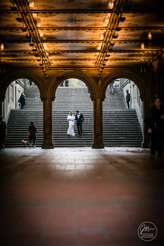 The couple descend the grand staircase at the Bethesda Fountain in Central Park. Image captured by wedding photographer Josh Wong 