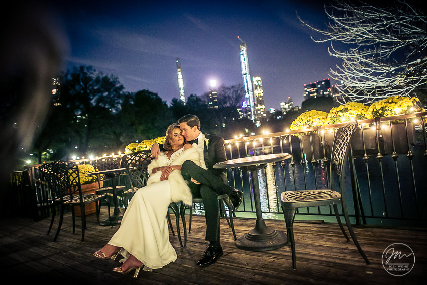 The newlywed couple enjoy a moment with the nighttime New York skyline.