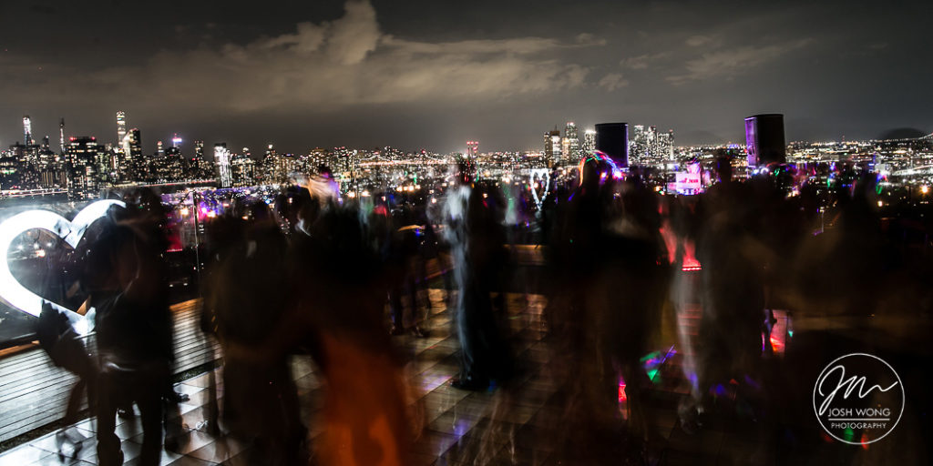 The rooftop night scene as guest dance the night away at The William Vale. Wedding photos by Brooklyn Wedding Photographer Josh Wong Photography