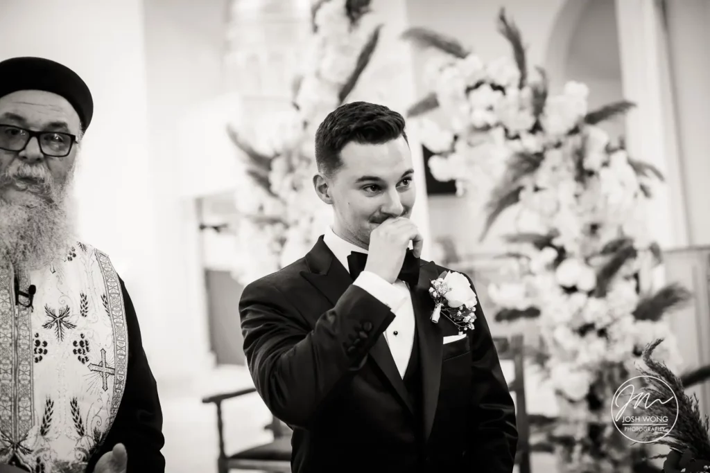 The groom see his bride for the first time walking down the aisle. Best wedding candid moments. An Egyptian Coptic Wedding Ceremony by New Jersey top wedding photographer Josh Wong Photography