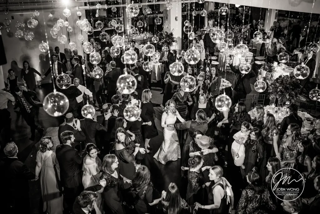 The bride and guest dance the night away. Captured by top NYC Wedding Photographer Josh Wong Photography