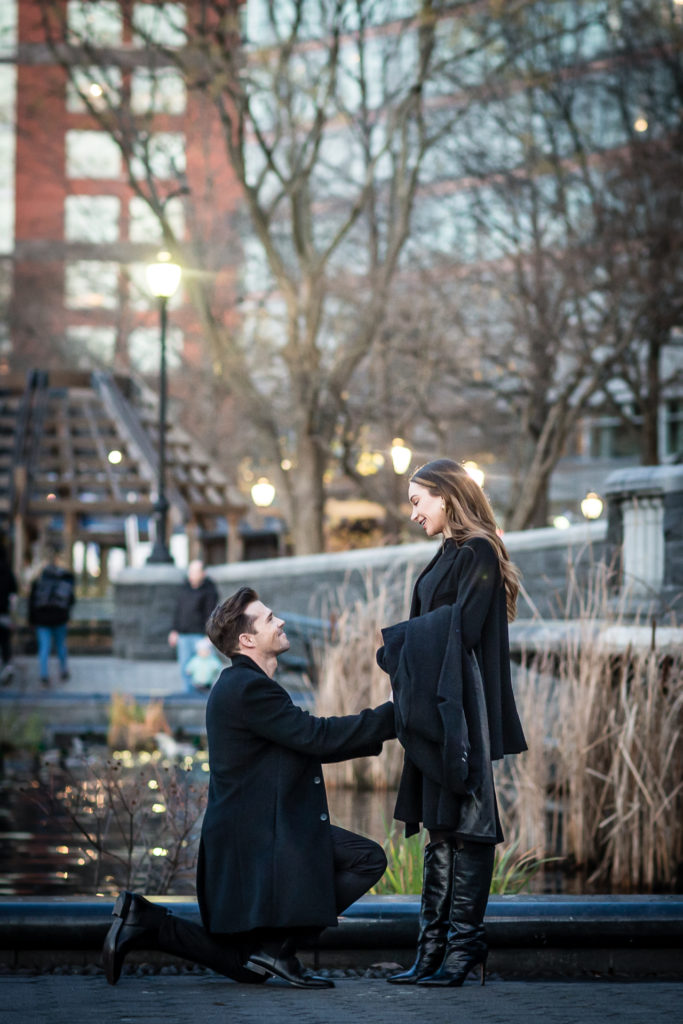 A romantic marriage proposal in Battery Park's Lily Pond. wedding proposal inspiration. Engagement photography by NYC wedding photographer Josh Wong Photography