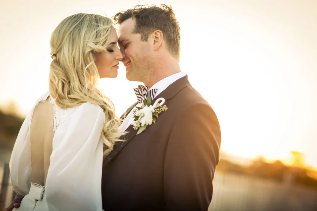 Newlyweds Katrina Szish and Marc enjoy an intimate moment with a beautiful sunset in at Rehoboth Beach in Delaware. Wedding photography by Josh Wong Photography