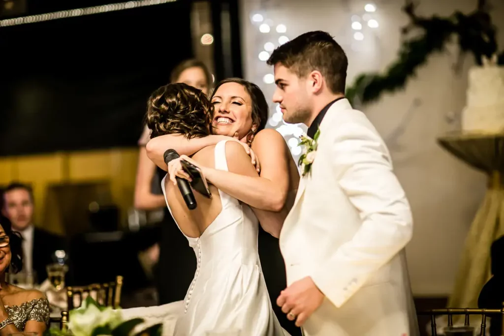 Maid of Honor hugs the bride after her MOA speech. Amazing candid moment captured by Josh Wong Photography