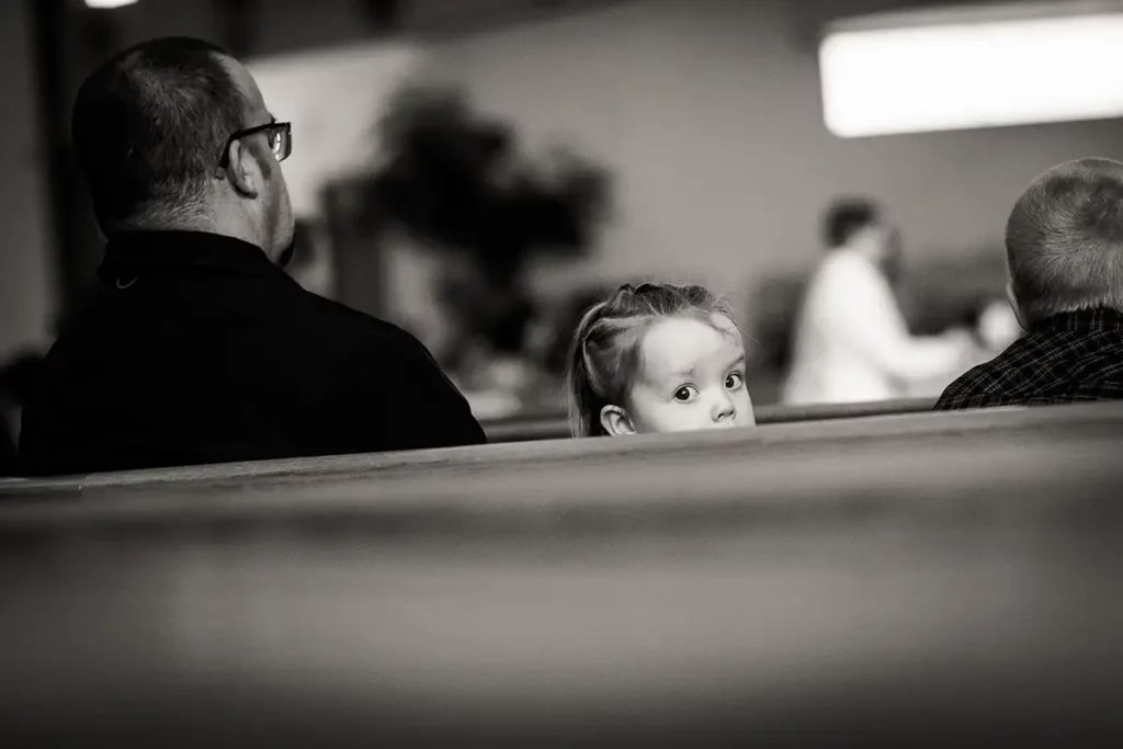 Sweet innocent child watch the bride walking down the church aisle. photo by Josh Wong Photography